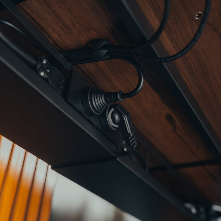 Desky integrated cable power channel in black attached to desk