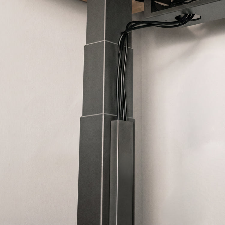 Black Desky magnetic cable management attached on legs