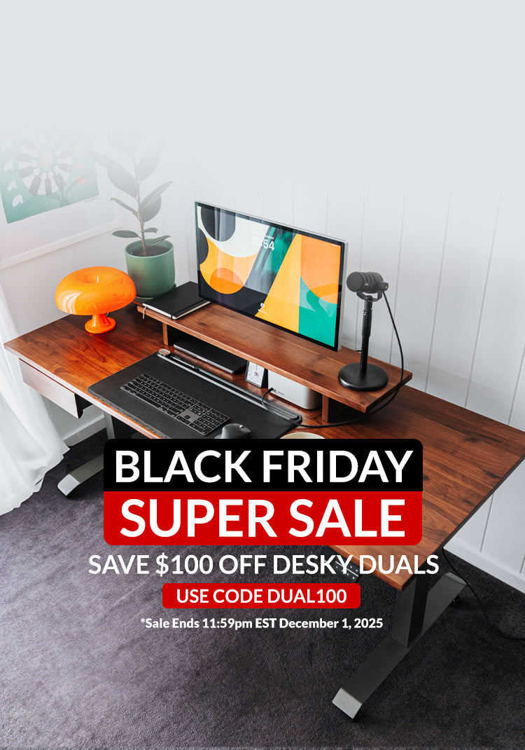 Wooden desk setup with computer equipment and Black Friday sale text overlay