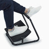 Person wearing white shoes using elevated footrest