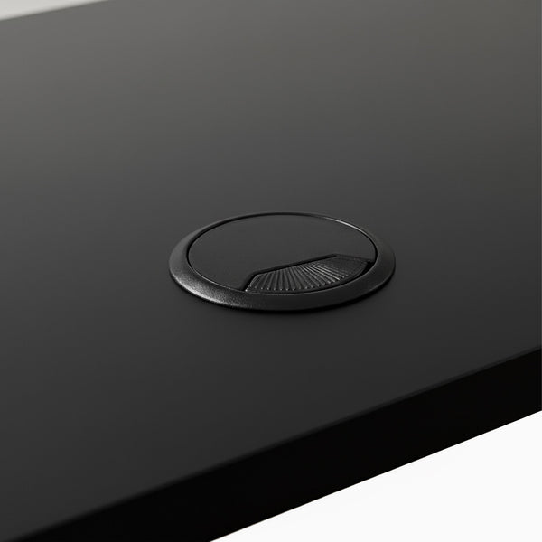 Black grommet hole on black desk