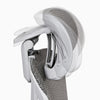 Close-up of an ergonomic office chair showing the headrest and white frame on a light gray background.