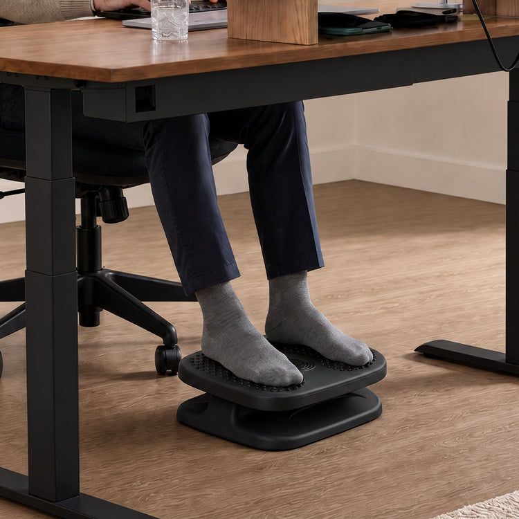 Feet resting on top of height adjustable ripple foot rest